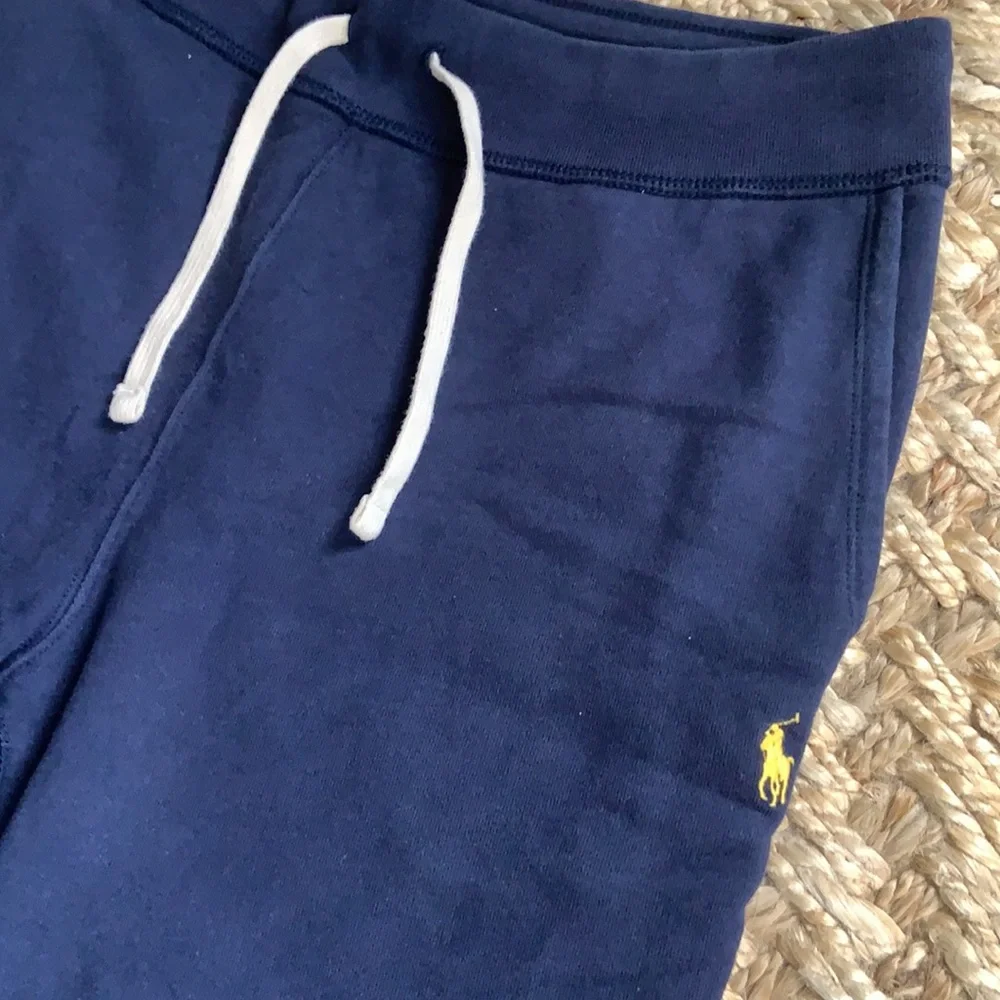 Polo navy sweatpants, two pockets, one in back, toes on the ankles.